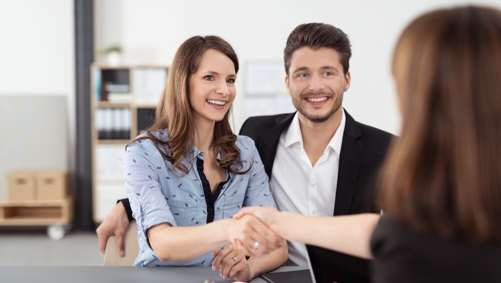 woman-with-partner-shaking-hands-with-person