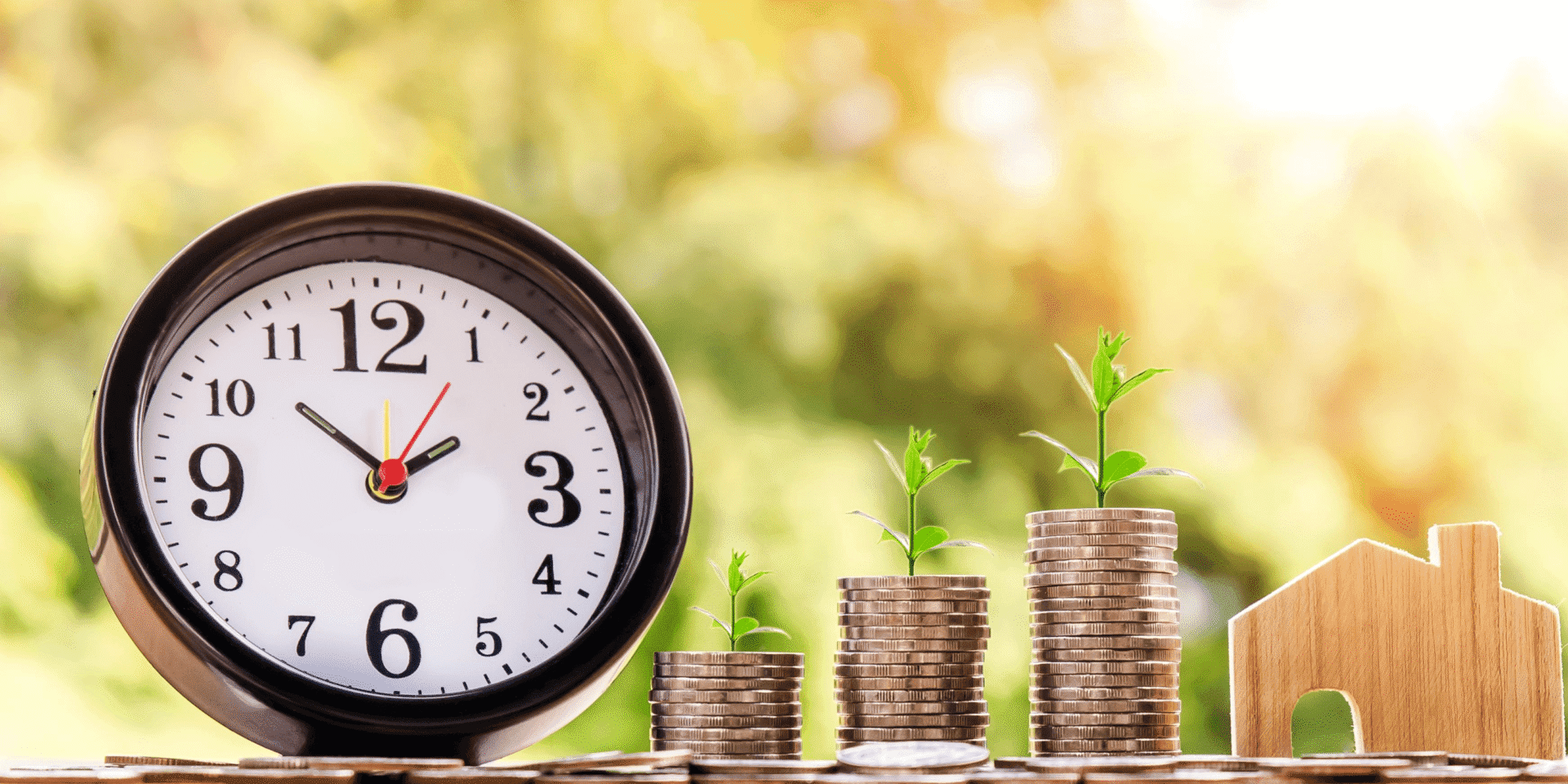 a timer with stack of coins beside and plants rising from the coins
