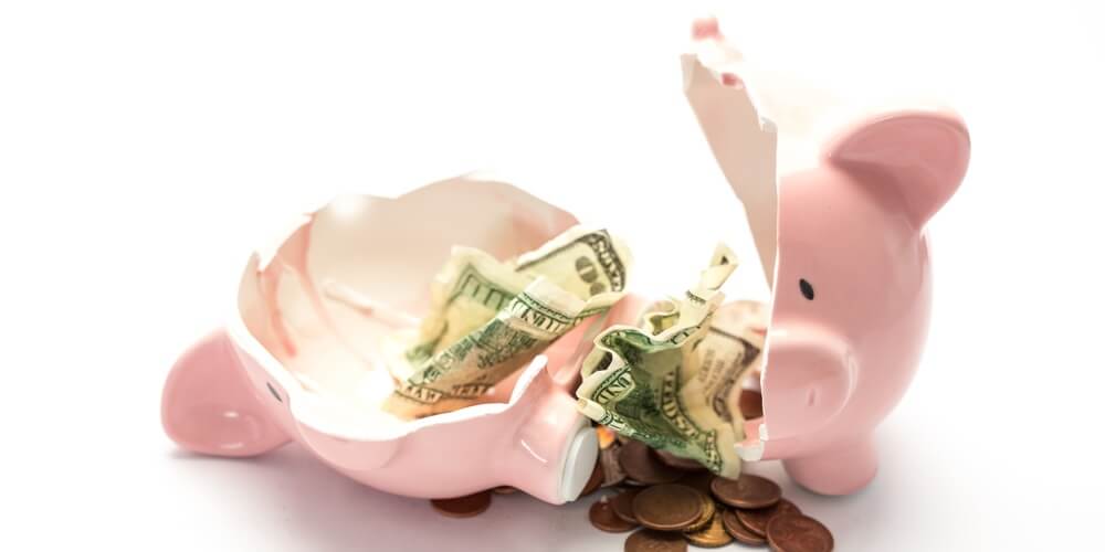 a broken piggy bank with money