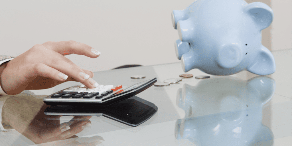 a image of hand doing a calculator with blue piggybank